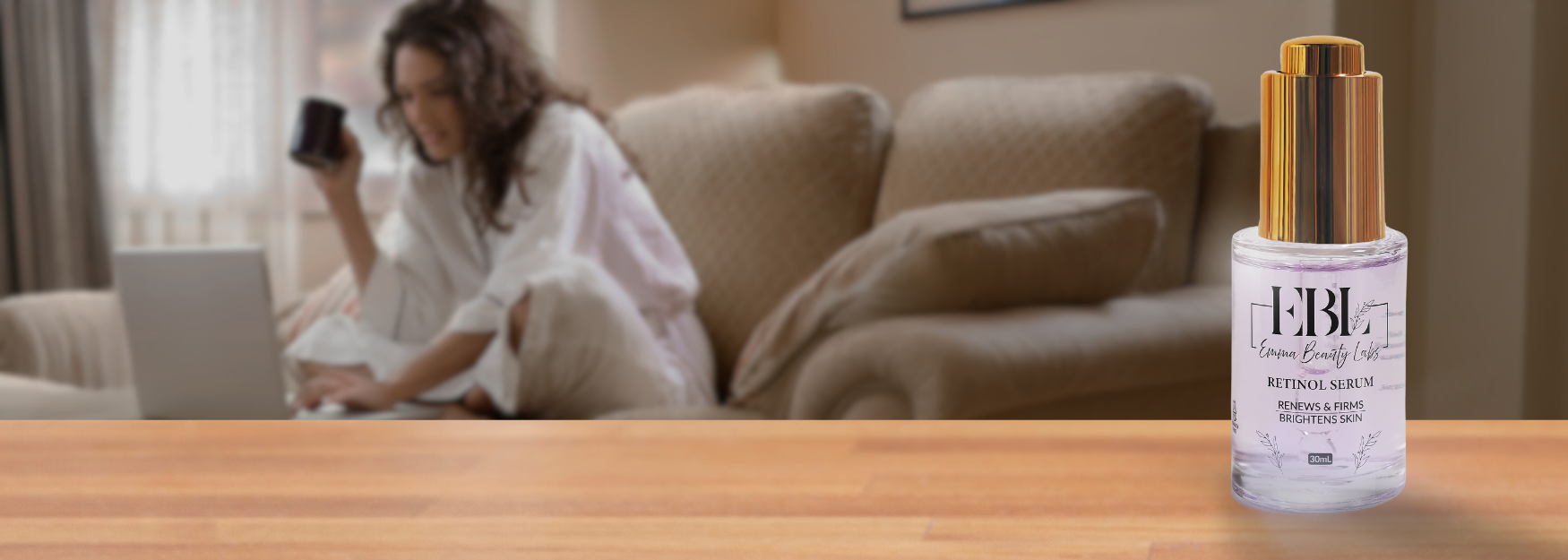 Woman working on laptop with retinol in forground