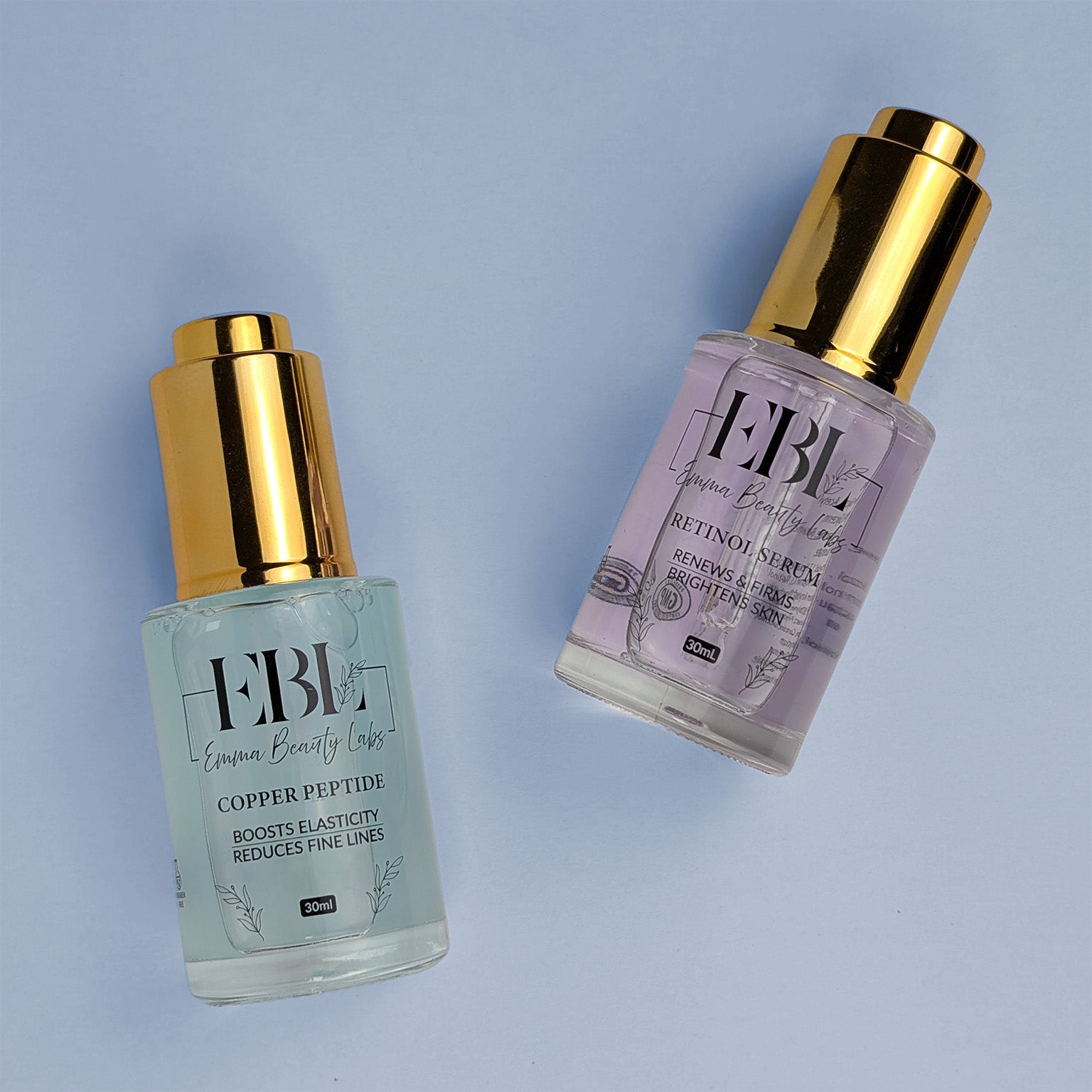 Two serums laying down. Copper Peptide Serum and Retinol Serums